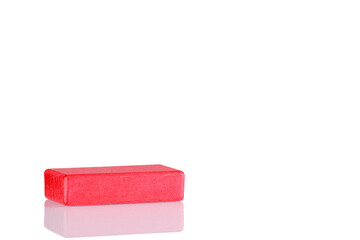 Wooden cube of red color on a white background