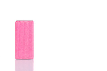 Wooden cube of pink color on a white background