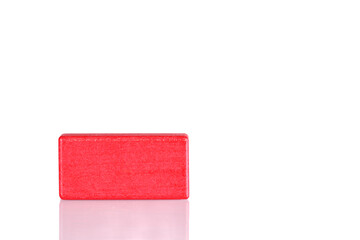 Wooden cube of red color on a white background