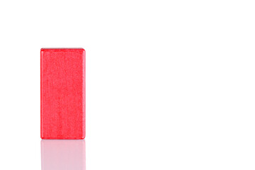 Wooden cube of red color on a white background