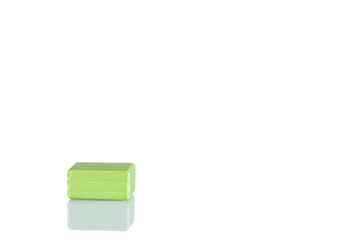 Wooden cube of green color on a white background