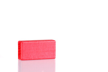 Wooden cube of red color on a white background