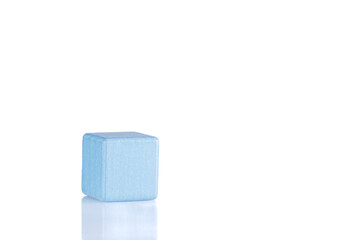 Wooden cube of blue color on a white background