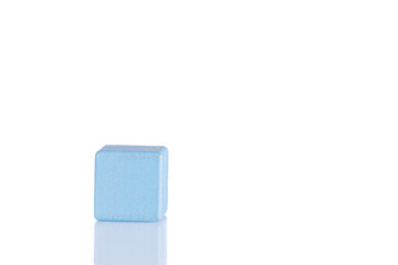 Wooden cube of blue color on a white background