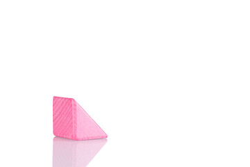 Wooden triangle of pink color on a white background