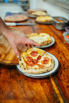 maestro pizzero sirviendo una pizza
