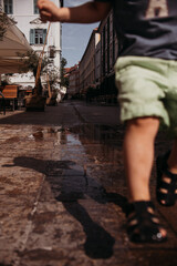 Obraz na płótnie Canvas shadow of the baby jumping on the street