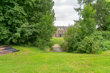 Main house at Landgoed Heerlijkheid Mariënwaerdt in The Netherlands, with water in front.