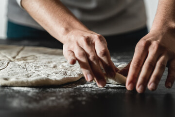 Chef preparing homemade bread inside kitchen on wooden board - Pastry and food concept