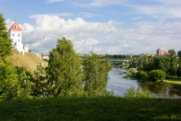  Neighborhood of Grodno, Belarus. Summer landscape overlooking the Neman River and the old castle on a high hill surrounded by green trees in the sun.