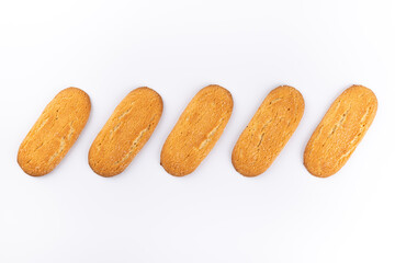 Elongated sugar cookies in a line on a white background. Breakfast and sweet snacks