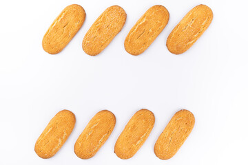 Lines of elongated sugar cookies on a white background. Copy space