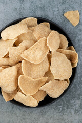 Thai shrimp rice crackers on gray background. Thai snack. Indonesian shrimp crackers - Kerupuk udang.