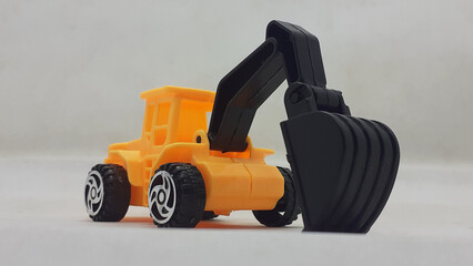 Fototapeta premium Yellow Black Realistic Modern Industrial Builder Vehicle Machinery Miniature Toys Model for Kids in White Isolated Background