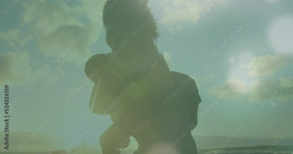 Canvas Prints Animation of light spots over biracial couple at beach