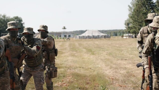 There is a group of soldiers with ammunition and weapons on the battlefield, attempting to attack the enemy. They are members of the Military Special Forces Unit.