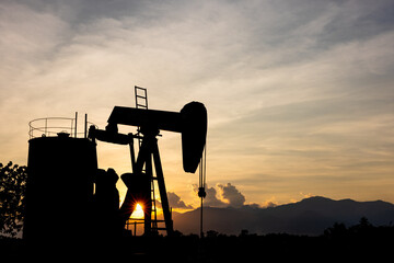 silhouette Oil pump oil rig energy industrial machine for petroleum in the sunset background