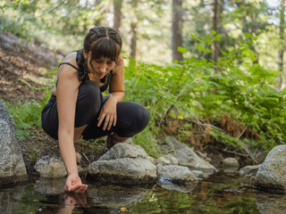 Fototapeta premium Indigenous young woman near a body of water