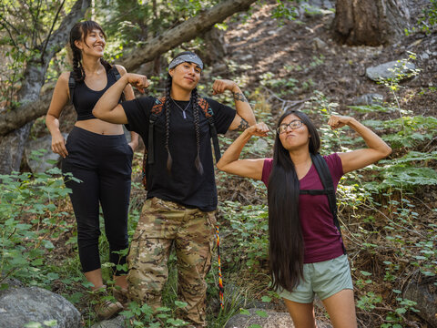 Indigenous young friends hiking in nature