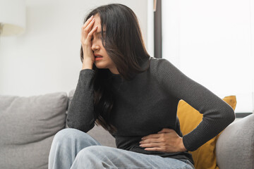 Flatulence asian young woman, girl hand in stomach ache, suffer from food poisoning, abdominal pain...