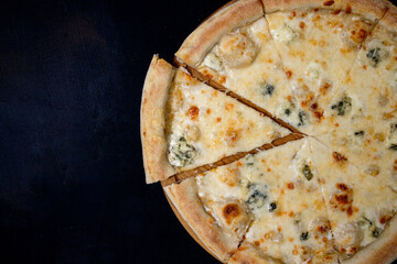 Pizza with four cheeses, mozzarella, blue cheese, Parmesan cheese. Italian cuisine on black...