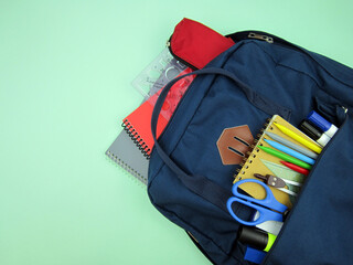    As COVID-19 prevention goes back to school and new normal concept. Top view of backpack with...