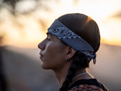 Side profile of a young native man wearing a bandana 