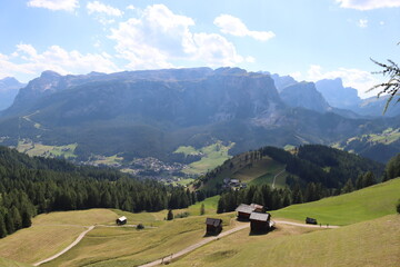 Val Badia, Italy-July 17, 2022: The italian Dolomites behind the small village of Corvara in summer days with beaitiful blue sky in the background. Green nature in the middle of the rocks.