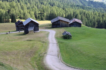 Val Badia, Italy-July 17, 2022: The italian Dolomites behind the small village of Corvara in summer days with beaitiful blue sky in the background. Green nature in the middle of the rocks.