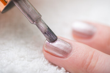 Manicure of fingernails. Painting in silver color