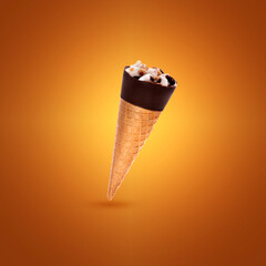 Ice cream in a waffle cup with chocolate and nuts. Ice cream on yellow background