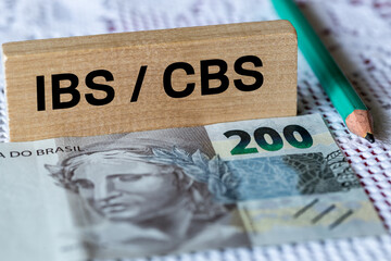 Brazilian 200 reais banknote, inscription on a wooden block IBS, CBS, Concept, Brazilian tax...