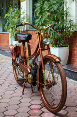 Fototapeta na wymiar close-up wheel retro motorcycle, bronze motorbike. vietnamese motorcycle. beautiful retro moped