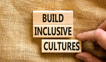 Build inclusive cultures symbol. Concept words Build inclusive cultures on wooden blocks....