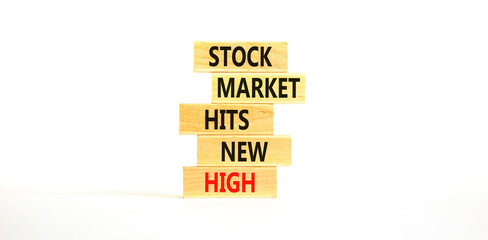 Stock market hits new high symbol. Concept words Stock market hits new high on wooden blocks on a beautiful white table white background. Business and stock market hits new high concept. Copy space.