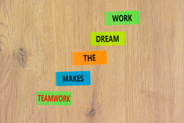 Teamwork makes the dream work symbol. Concept words Teamwork makes the dream work on color papers on a beautiful wooden background. Business Teamwork makes dream work concept. Copy space.