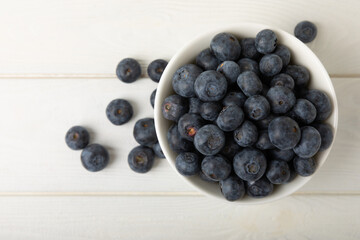 Blueberries in a bowl on white textured background. Ripe and fresh blueberries. Vitamins. Healthy food. Juicy berry.Copy space.Place for text