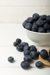 Blueberries in a bowl on white textured background. Ripe and fresh blueberries. Vitamins. Healthy food. Juicy berry.Copy space.Place for text