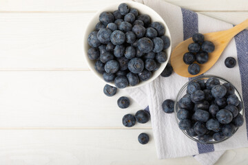Blueberries in a bowl on white textured background. Ripe and fresh blueberries. Vitamins. Healthy food. Juicy berry.Copy space.Place for text