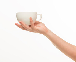 female hands hold a white cup on a white background isolated