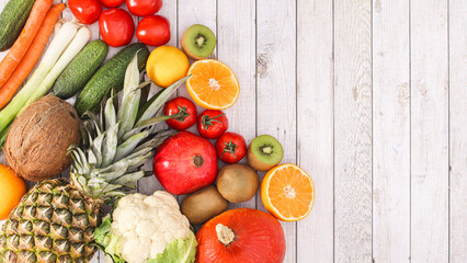 Exotic summer fruits and vegetables on wooden background. Flat lay healthy food concept