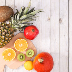 Exotic summer fruits on wooden background. Flat lay healthy food concept