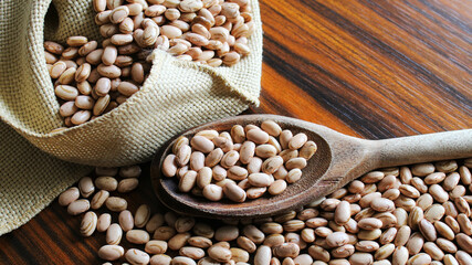 Carioca beans. Brazilian grains carioca beans in a wooden spoon.