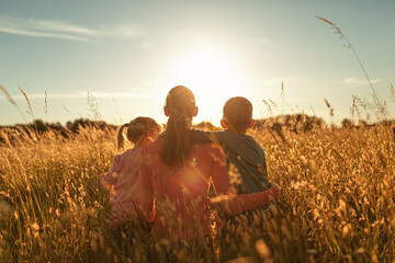 Mother spending time with her children in outdoors nature	