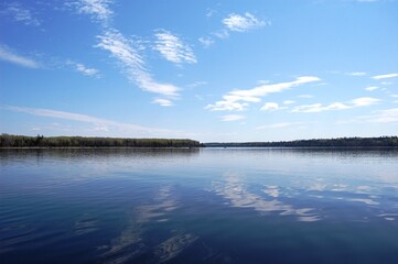 Breathtaking view of the natural reflections cast upon the calm glossy waters of Lac Seul, Ontario, Canada.