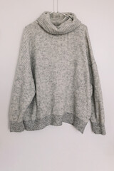 Warm woolen knitted sweater on the hanger