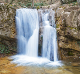 Fototapeta na wymiar beautiful small waterfall in mountain, beautiful natural background