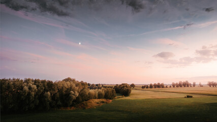 View of the meadow during the sunset in the Polish countryside
