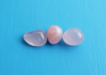 Three tumbled rose quartz stones. Semi-precious rose quartz crystals are a love talisman for women.