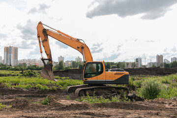 Crawler excavator digs the earth with a bucket. Drainage of swamps. Peat mining. Excavators are used when working in quarries and mine workings.